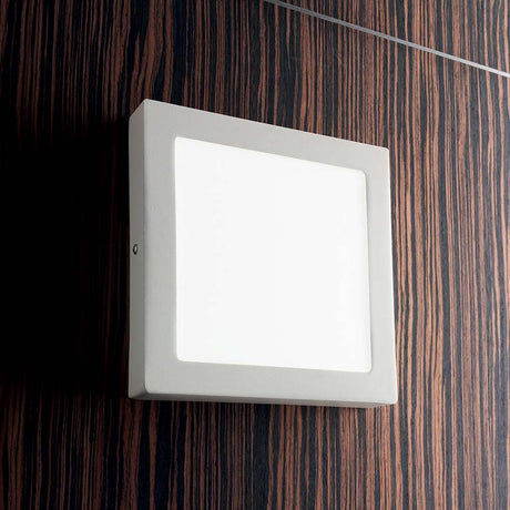 Universal 18W Square White wall light mounted on a wall, modern design for indoor spaces.