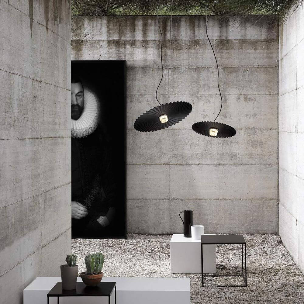 Karman Gonzaga LED Außen-Hängeleuchte IP65 in modernem Raum mit Betonwänden und minimalistischer Einrichtung.