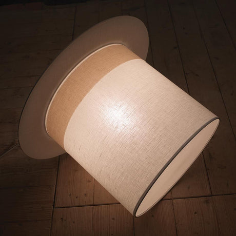 Karman WOW cylinder pendant light for Silvan rabbits in a stylish design and warm light on a wooden floor.
