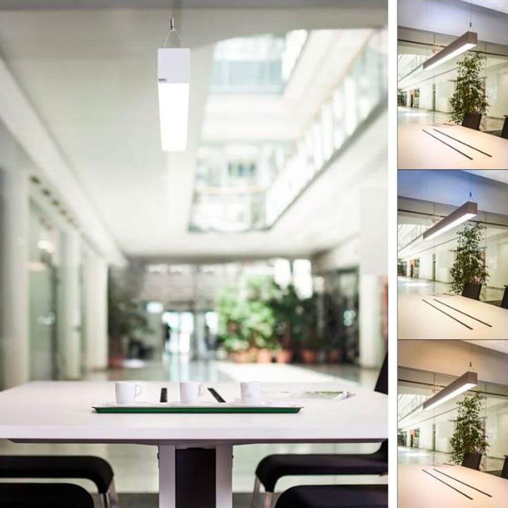 Moderne K-Horizon LED Bürolampe in einem hellen Innenraum über einem Tisch mit Pflanzen, verschiedene Beleuchtungseinstellungen.