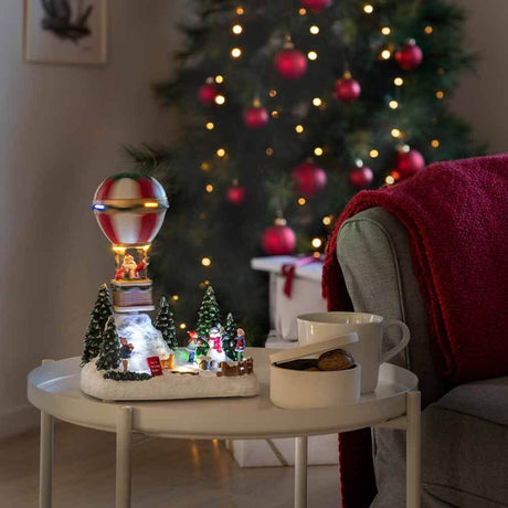 LED Decorative hot air balloon light with music & 13 multicolored LEDs in a cozy Christmas setting.