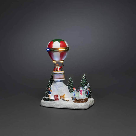 LED Decorative hot air balloon light with music & 13 multicolored LEDs in a winter scene.
