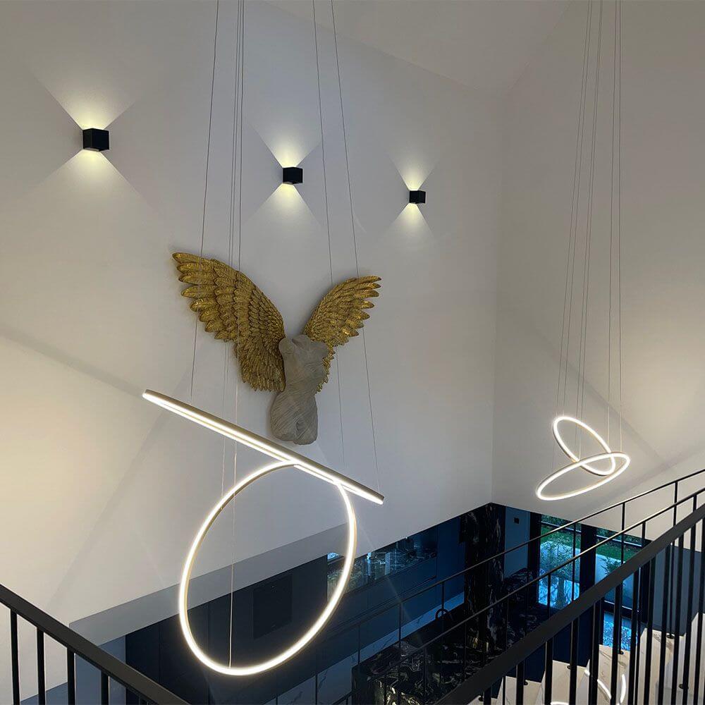 s.luce LED ring pendant light 2-flame central in a modern space with sculptural elements.