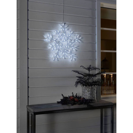 LED Acrylic snowflake with 8 functions 90 cool white diodes IP44 shines on the wall as festive decoration.