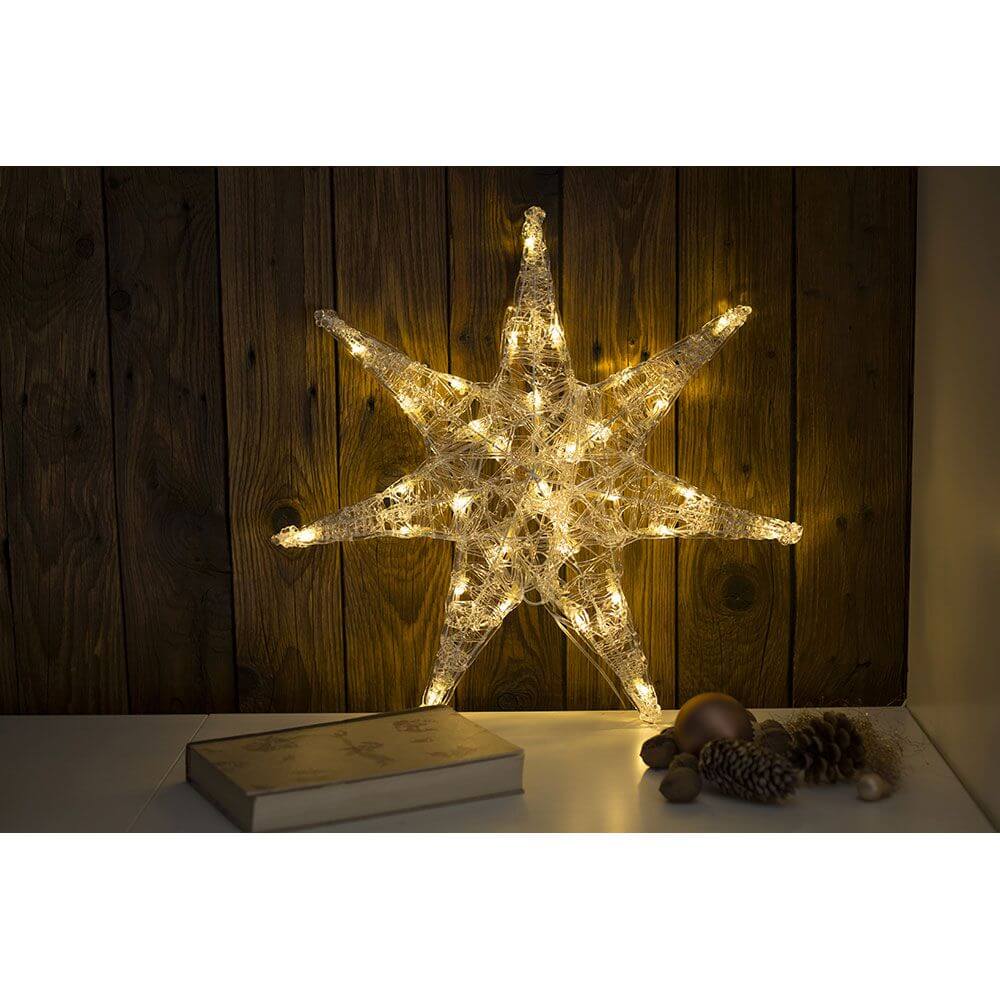 LED Acryl Stern groß 32 Warmweiße Dioden leuchtet sanft in einem gemütlichen Raum.