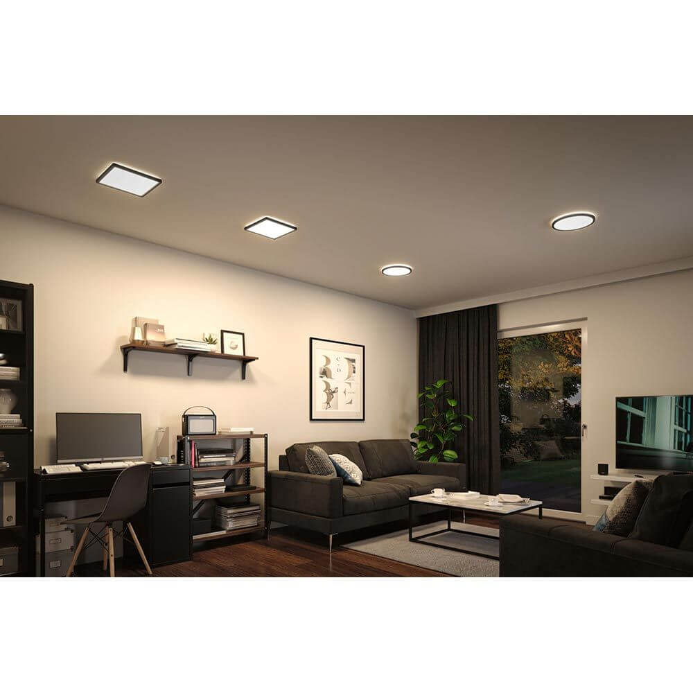 LED Atria Shine Panel Rund Schwarz in modernem Wohnzimmer mit gemütlicher Atmosphäre.