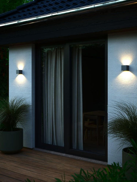 LED Outdoor wall light Milda kubi IP44 on a modern wall with lighting effects.
