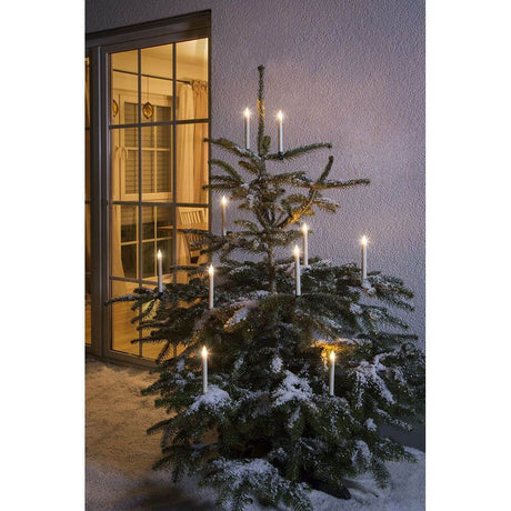 5 LED candle add-on set for 1930-100 5 warm white IP44 on a decorated Christmas tree at night.