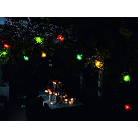 LED Beer garden string lights 10-piece multicolour 80 warm white diodes 24V shining in the dark above a table.