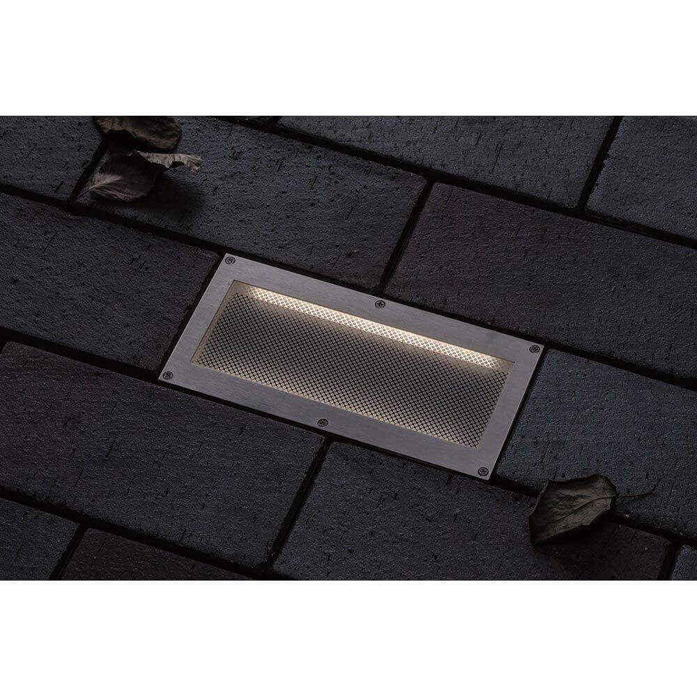 LED Bodeneinbauleuchte Brick mit Bewegungsmelder IP67 auf einem Pflastersteinboden.