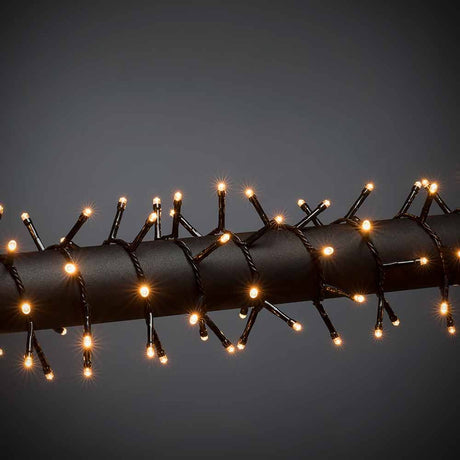 LED Cluster string lights Black on a black rod, glowing lights for festive decoration.