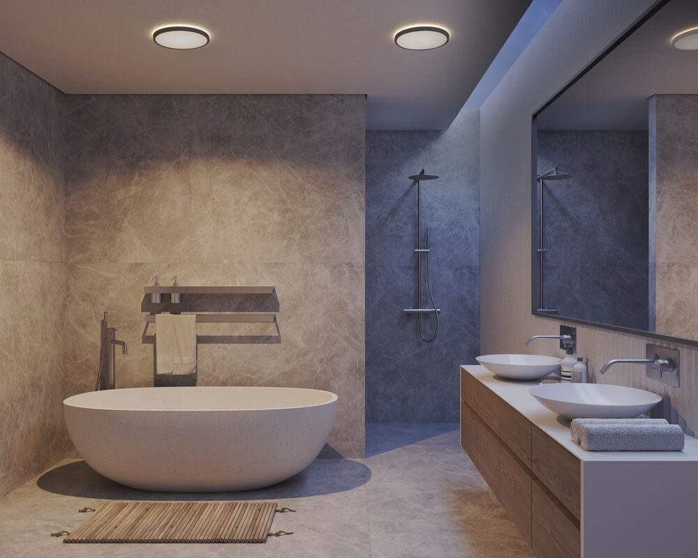 LED Deckenleuchte Oja 42 3-Stufen IP54 in modernem Badezimmer mit freistehender Badewanne und Doppelwaschtisch.