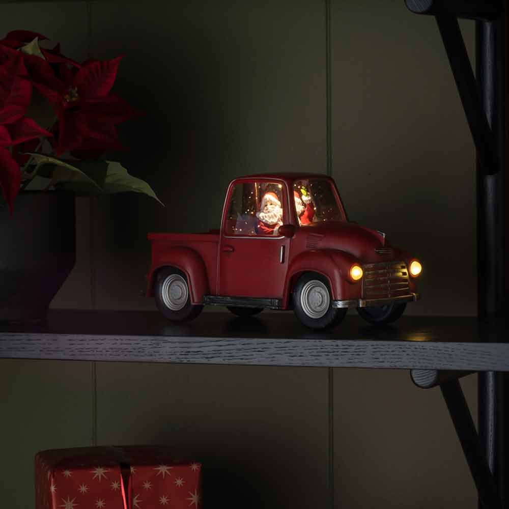 LED Dekoleuchte Pick-up mit Weihnachtsmann batteriebetrieben Rot auf Regal, leuchtende Scheinwerfer und Innenbeleuchtung