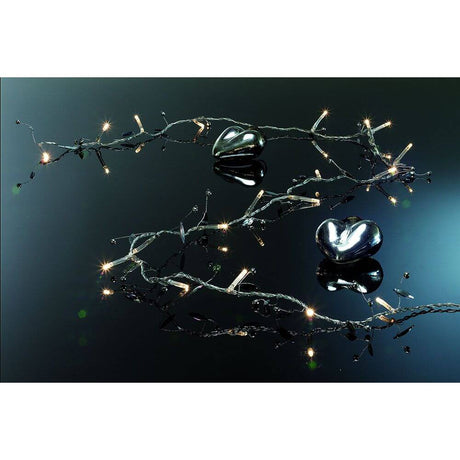 LED Decorative string lights glass beads 20 warm white diodes battery-operated, sparkling lights and heart decoration on a dark background.