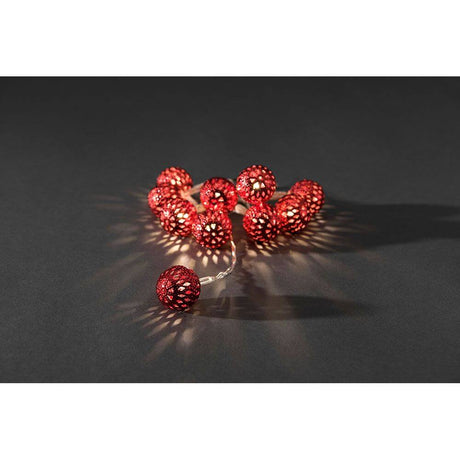 LED decorative string lights small red metal balls 10 warm white diodes battery-operated on a dark background.