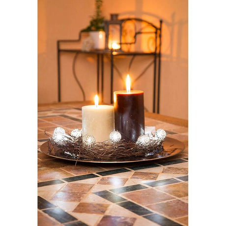 LED decorative light chain small silver-colored metal balls 10 cool white diodes battery-operated around candles on a decorative table