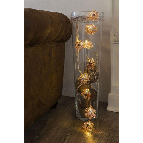 Decoration with LED decorative string lights copper-colored metal flowers 10 warm white diodes battery-operated in a glass container.