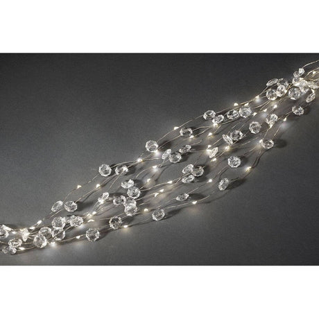 LED Diamond tinsel, 24 strands with 20 diodes, 480 warm white diodes on a dark background.