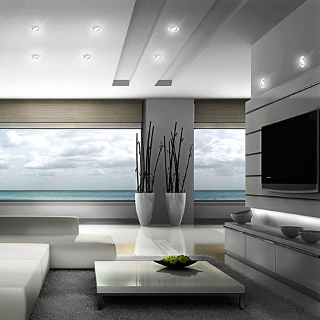Modern living room with LED Movibile recessed light IP44 chrome, elegant furniture design, and sea view.