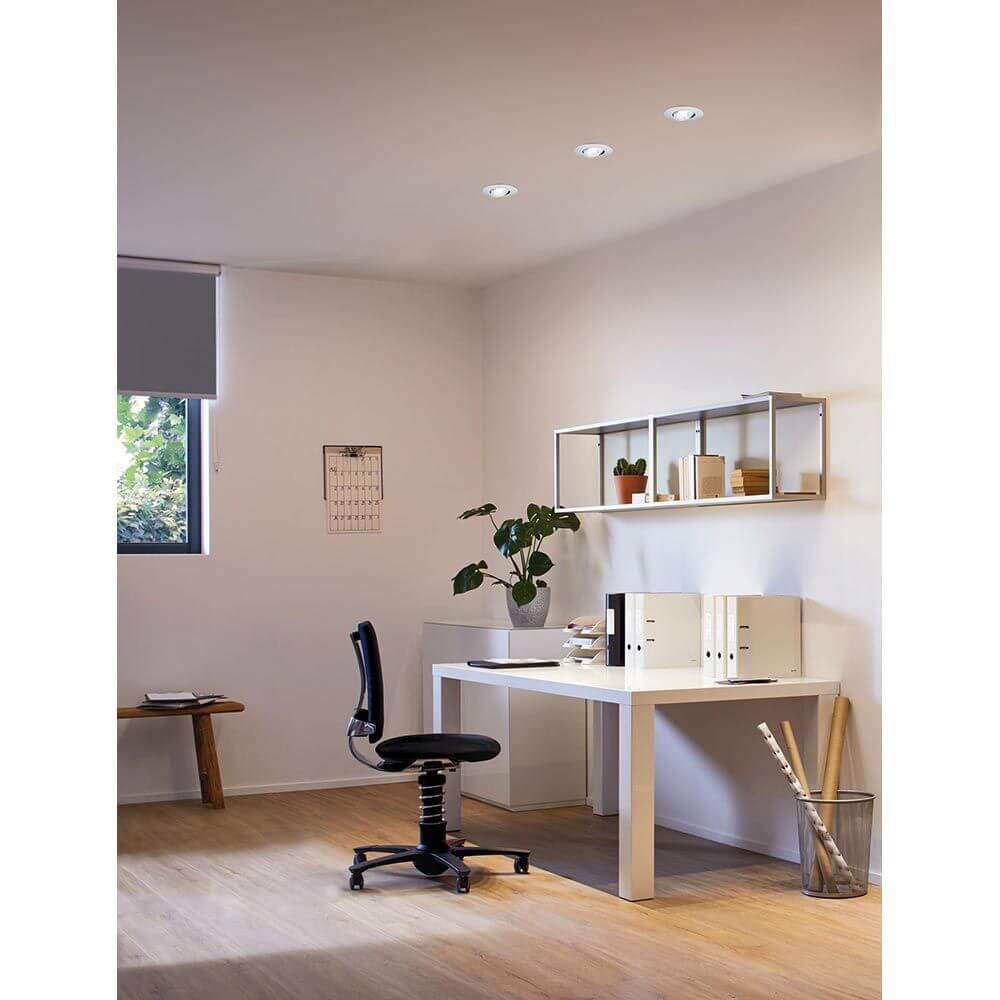 Moderner Arbeitsbereich mit LED Einbauleuchten, einem weißen Schreibtisch und ergonomischem Stuhl.