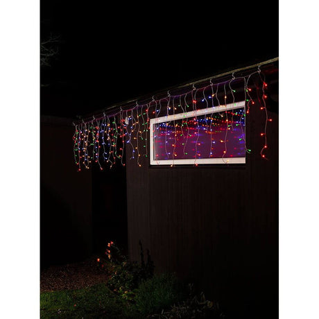 LED Icicle light curtain with colorful globes 200 colorful diodes IP44 hanging over a window in the dark.