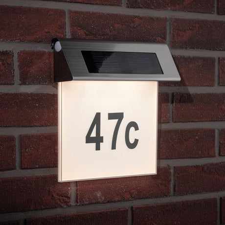 LED Solar house number light IP44 stainless steel, white with house number 47c mounted on a brick wall.