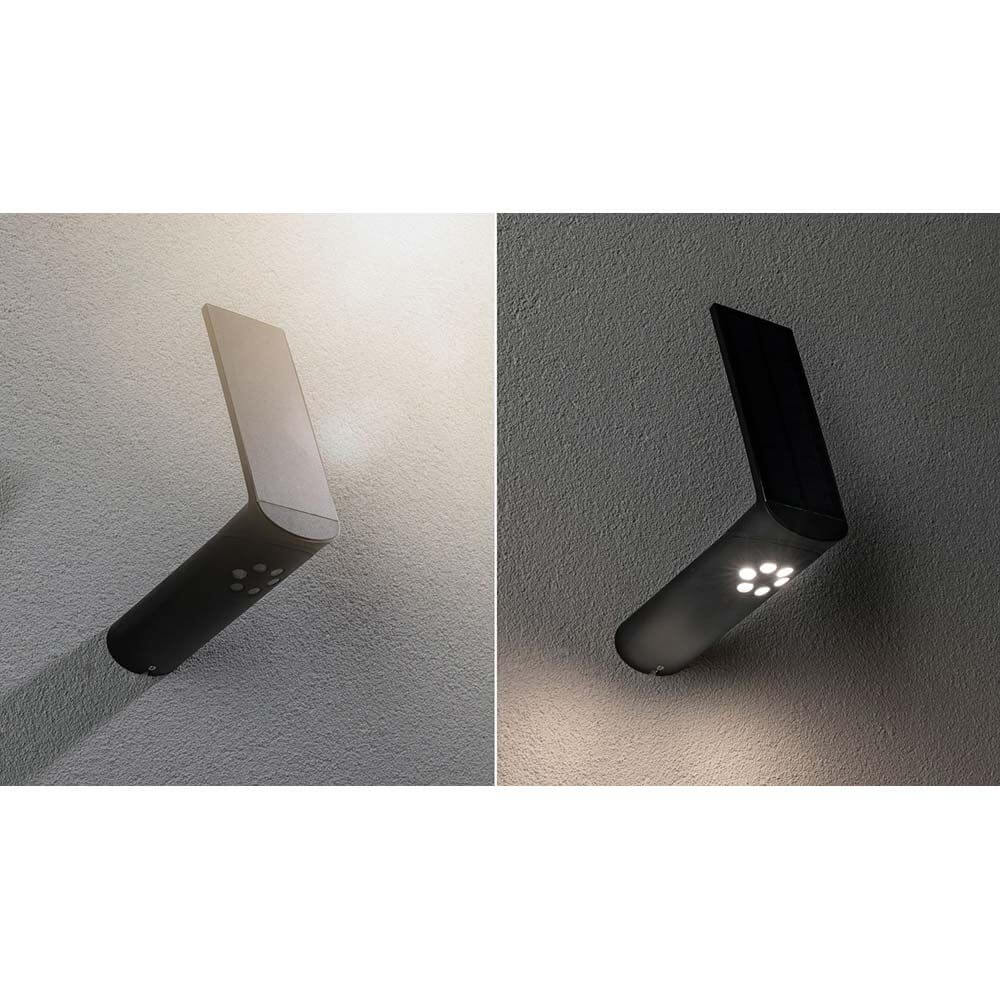 LED Solar-Wandlampe Ilias IP44 3000K Bewegungsmelder Anthrazit an Wand montiert, mit Solarpanel und Orientierungslicht.
