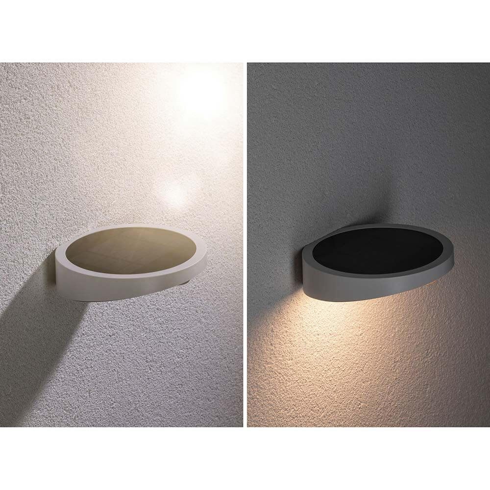 LED Solar Wandlampe Ryse mit Bewegunsmelder IP44 3000K Weiß an Wand montiert, zeigt Licht bei Dämmerung.