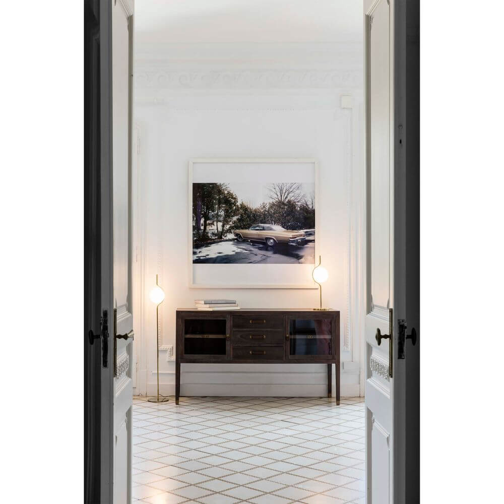 Moderne Einrichtung mit LED Stehlampe, Kunstwerk und eleganter Kommode im stilvollen Raum.