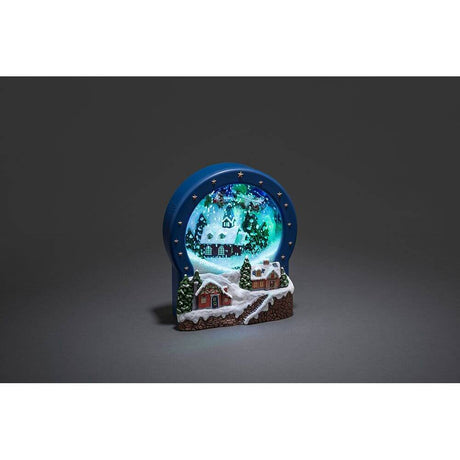 LED Dorf Glas mit Animation Weihnachtsliedern 9 bunte Dioden batteriebetrieben in verschneiter Landschaft.