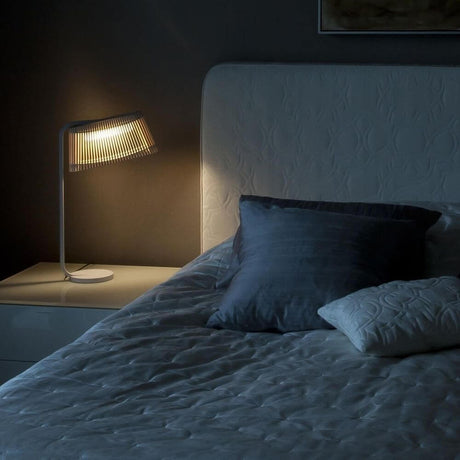 LED Owalo 7020 table lamp made of wood, 50 cm, on a bedside table in a relaxed bedroom atmosphere.