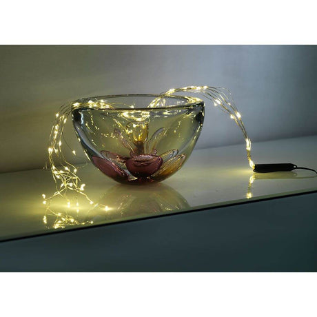 LED Drop tinsel 10 strands with 9 diodes 90 warm white diodes in a decorative glass bowl.