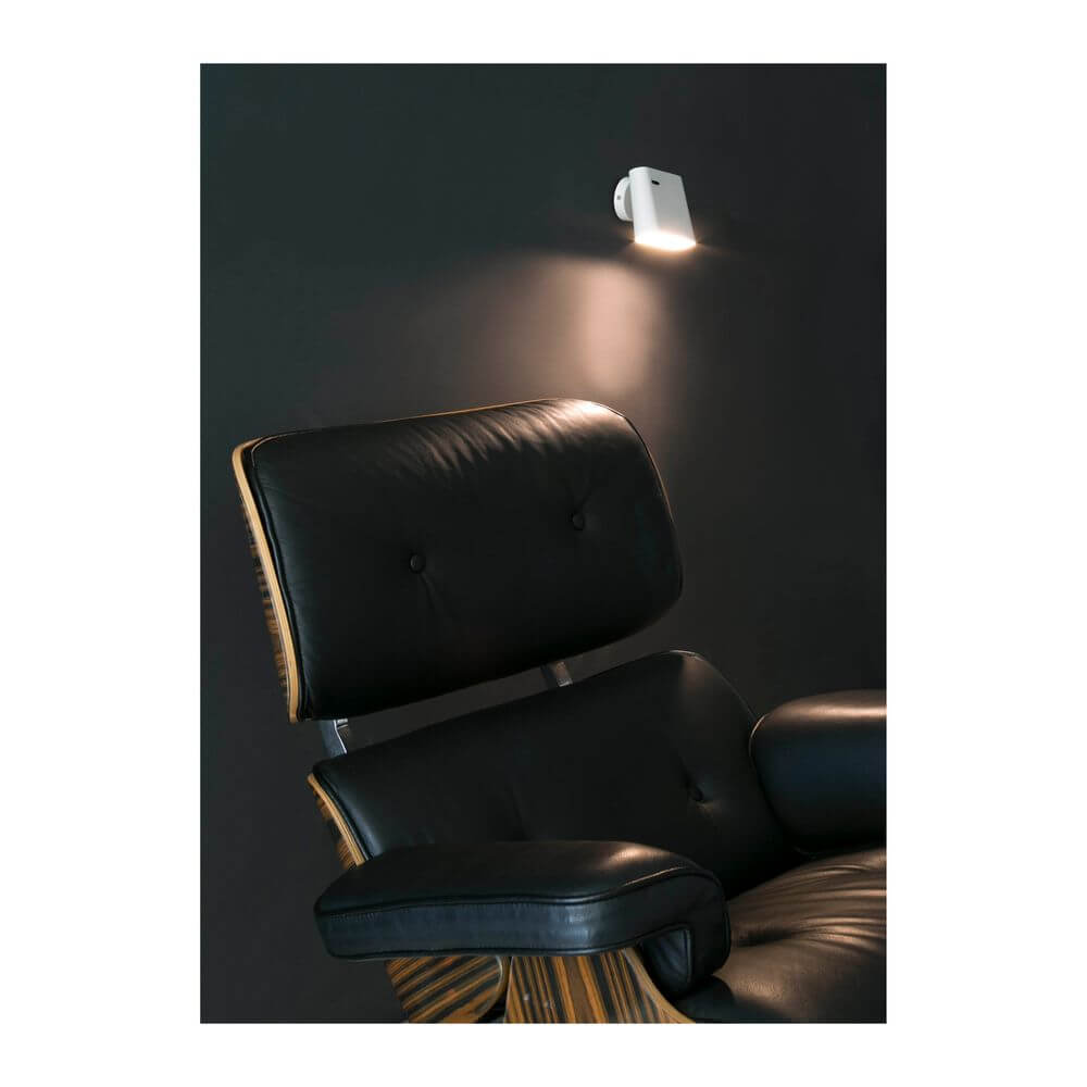 LED Wandleuchte AUREA 6W 2700K Weiß an einer Wand über einem gemütlichen Sessel