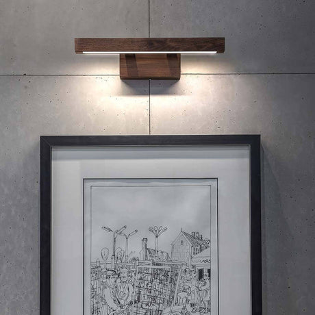 LED wall light Smal touch dimmer 490 lm walnut mounted on the wall above a frame.