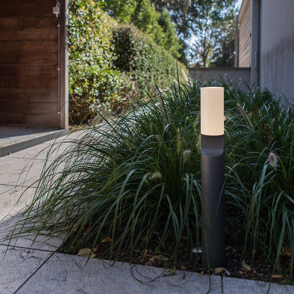 LED Wegeleuchte Bati IP44 65cm Anthrazit in einem Garten, akzentuiert durch grünes Gras und moderne Landschaftsgestaltung.