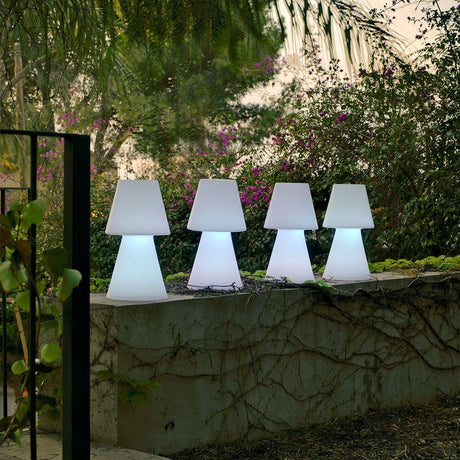 Lola LED outdoor table lamp Large in a garden, stylish outdoor lighting for any space.