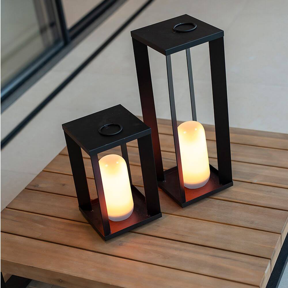 Siroco LED table & outdoor floor lamp flame effect in modern lantern design on a wooden table.