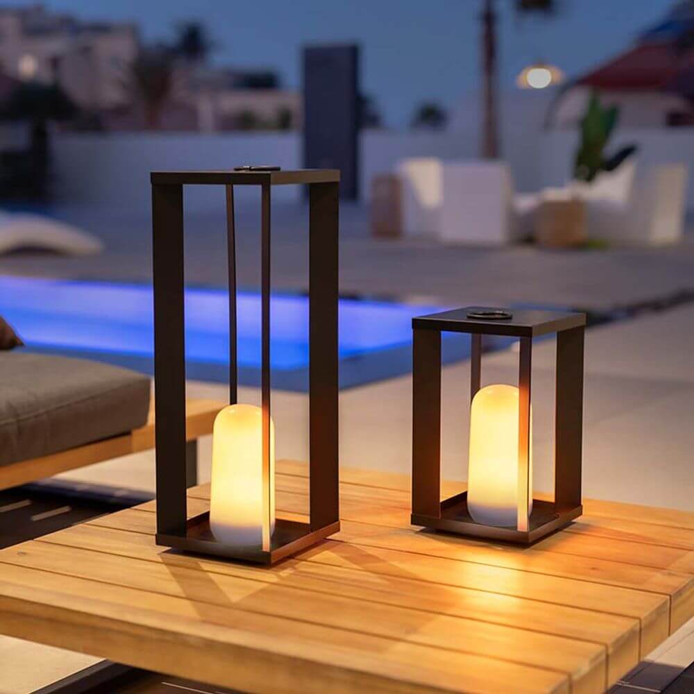 Siroco LED table & outdoor floor lamp flame effect on a table in the outdoor area at dusk.