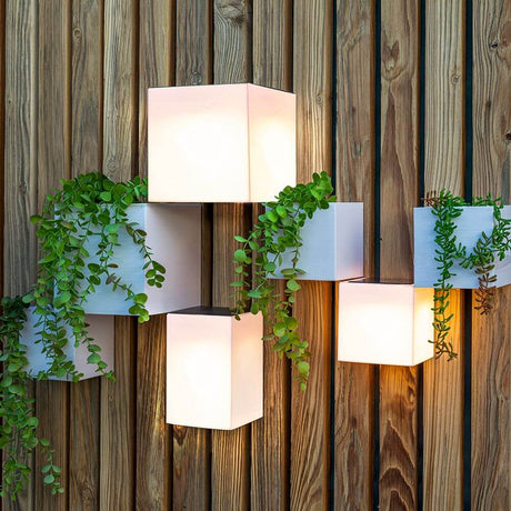 Wally LED cube wall light solar with plants on a wooden wall, stylish design for balcony and garden.