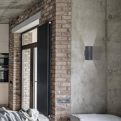 Tube wall light 2-light graphite on a brick wall in a modern living room.