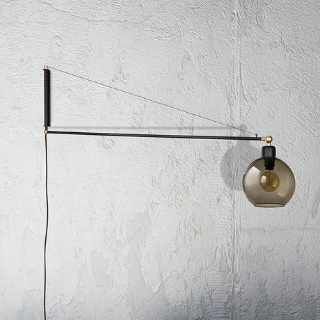 Wall light Crane for the socket Black mounted on a wall with glass globe.