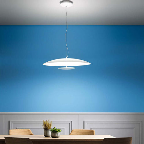 Horizon P LED pendant light above a table in a modern dining room with a blue wall.
