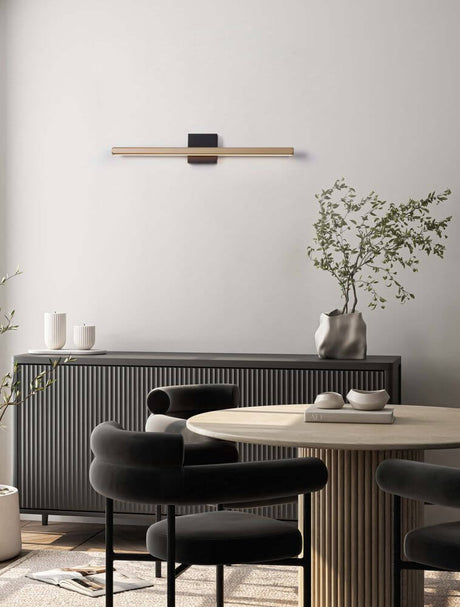 Lios LED wall light 3000K black, brown on a modern wall with plants and furniture.