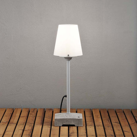 Lucca small patio light with a solid grey concrete base on a wooden terrace.