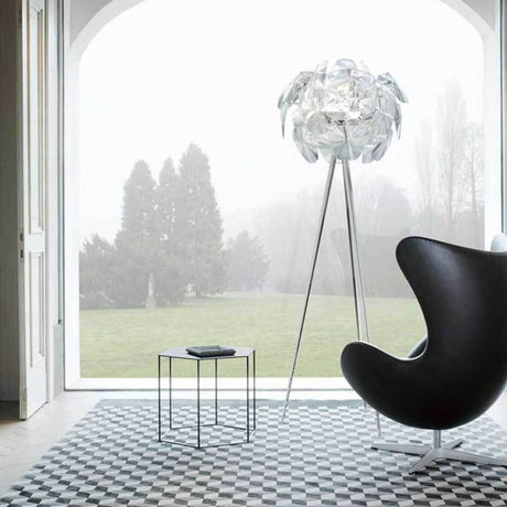 Luceplan Hope floor lamp Ø 72cm with dimmer in a modern living setting next to a black armchair.