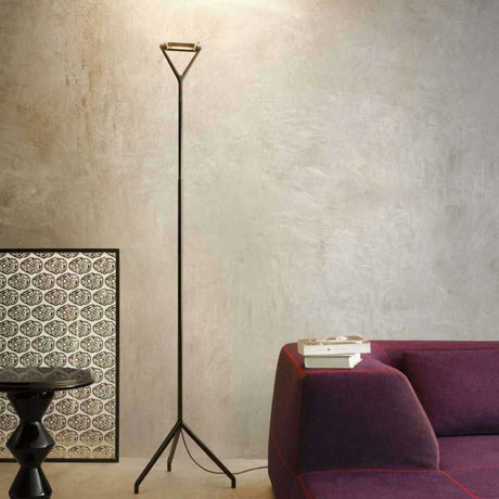Luceplan floor lamp Lola 200cm in a modern room, elegant shape standing next to sofa and table.
