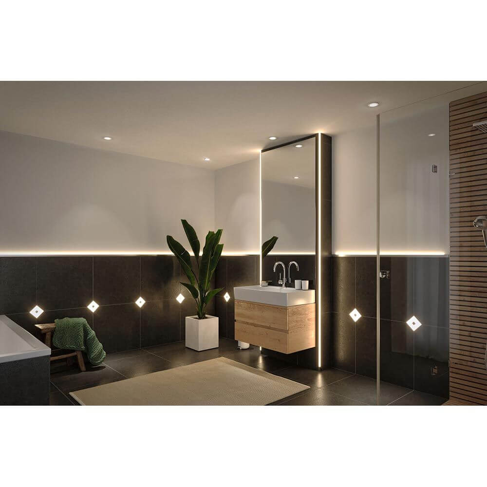Modernes Badezimmer mit LumiTiles LED Fliesen und stilvoller Einrichtung aus Holz und Pflanzen.
