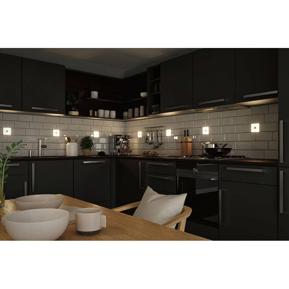 Moderne Küche mit LumiTiles LED Fliesen in Schwarz-Weiß, elegant und effizient beleuchtet.