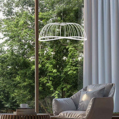 Celeste LED Large pendant light above a cozy armchair with a view of greenery.