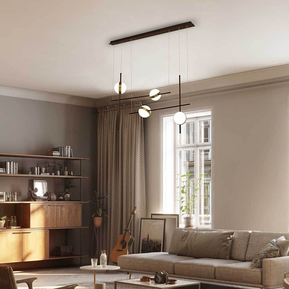 Cuba LED-Pendelleuchte Asymmetrisch in modernem Wohnraum mit Sofa und Bücherregal.